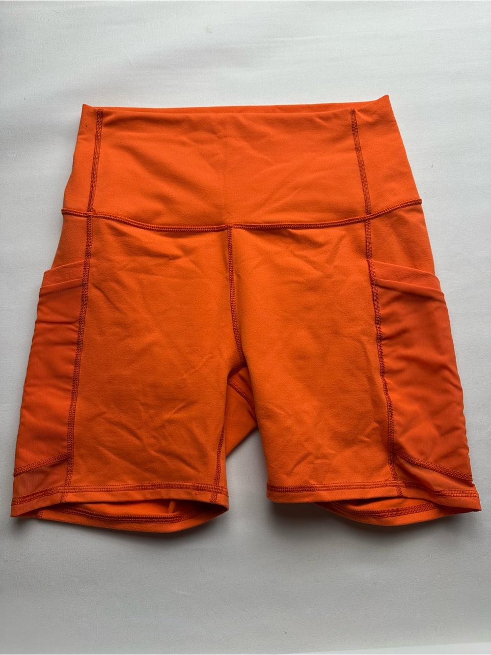High-Waist Pocket Bike Shorts by Fabletics - Orange. Est size S.